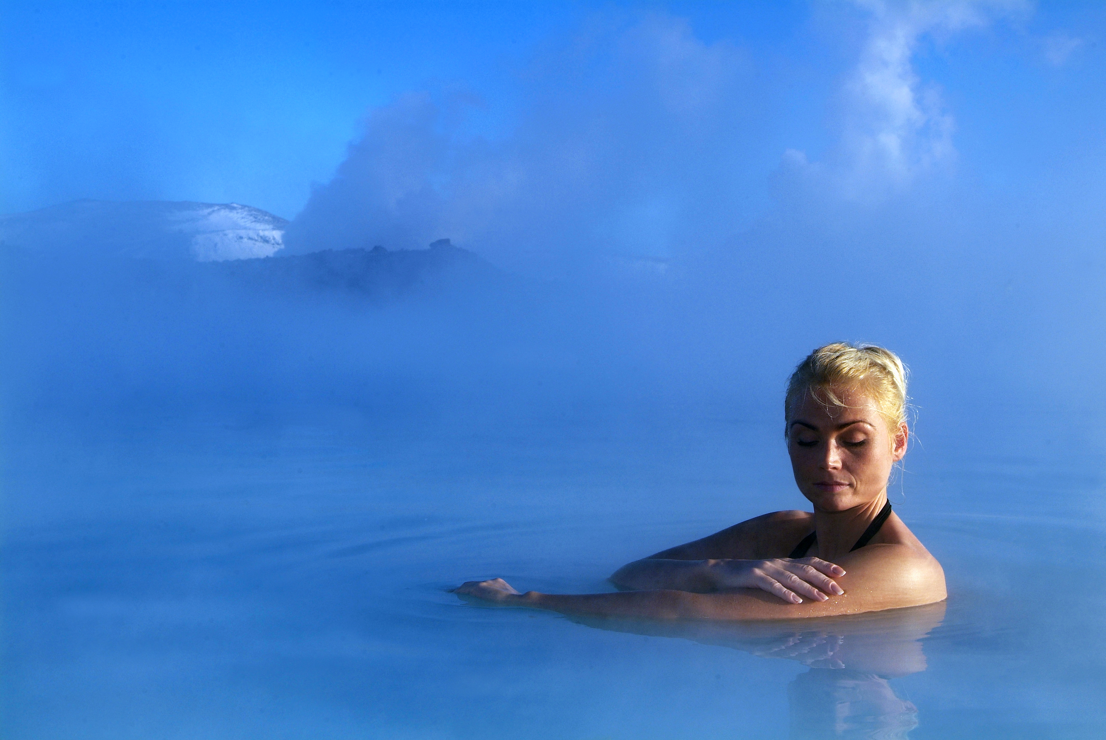 Woman bathing in the Blue Lagoon in Iceland